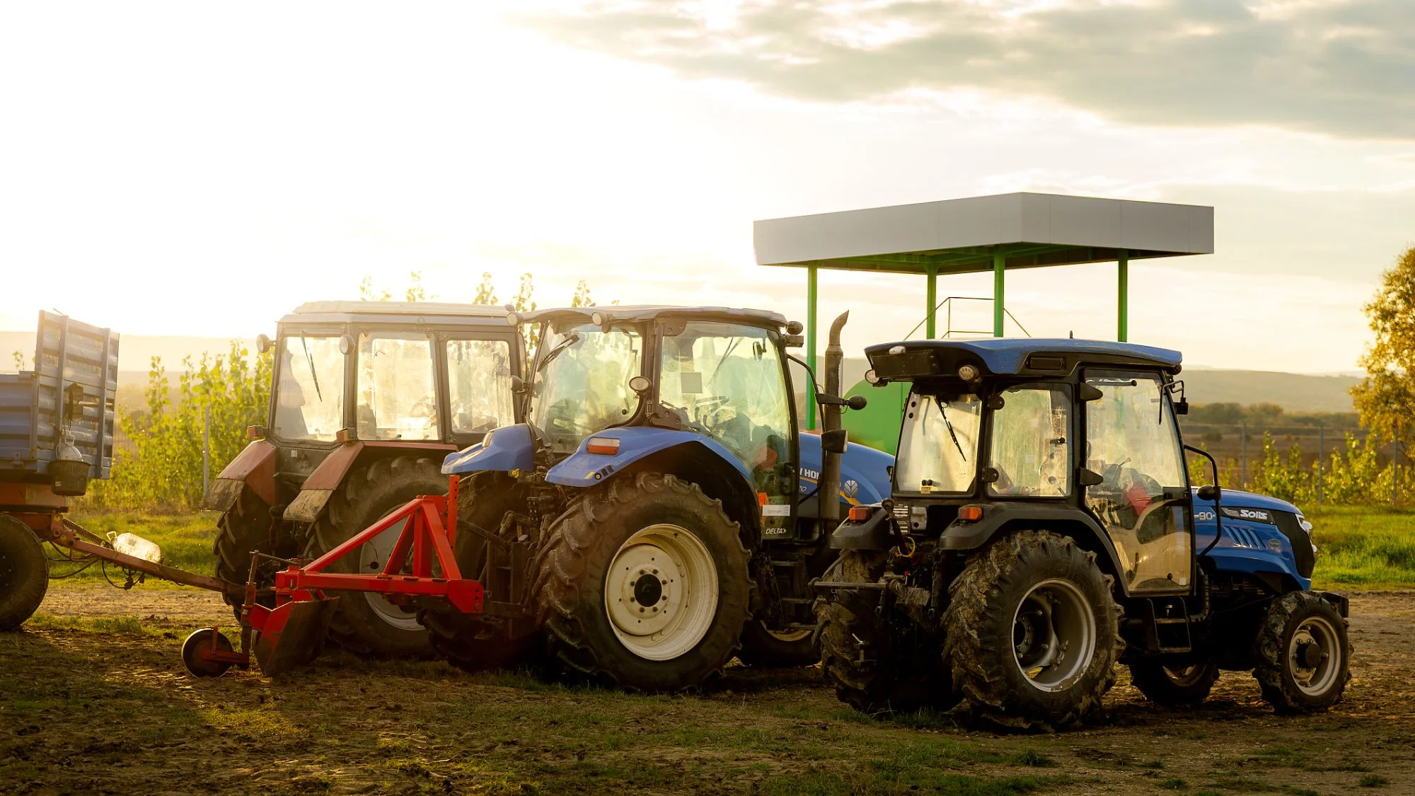 Noble Nuts tractor fleet at the edge of the orchard at sunset